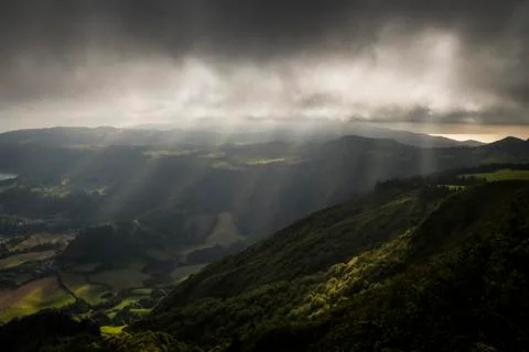 Sun rays illuminating the hills Stock Photos