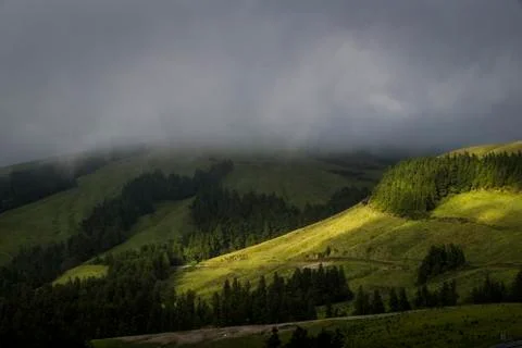 Sun rays illuminating the hills Stock Photos