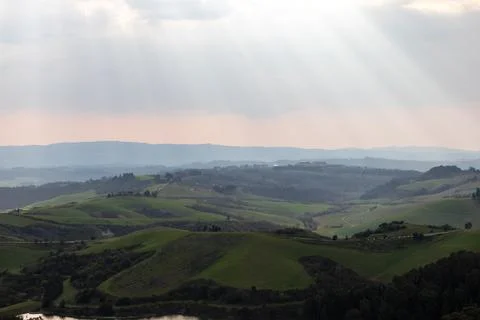 Sun rays illuminating rolling hills, Tuscany landscape, Castelfalfi, Italy Stock Photos