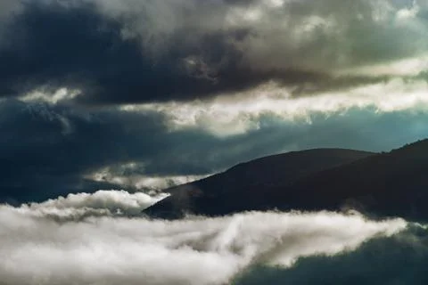 Sun rays lighting through the clouds in high Pyrenees Stock Photos