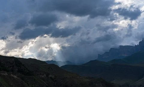 Sun rays make their way through the clouds Stock Photos