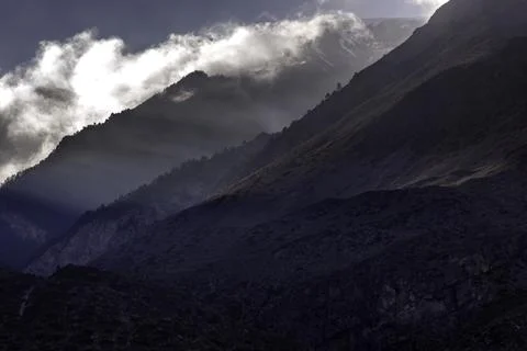 Sun rays in mountains and sky Stock Photos