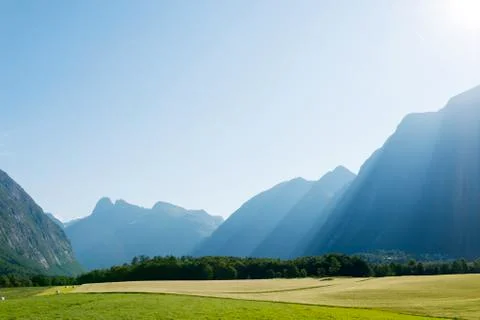 Sun rays in mountains lighting the valley, Norway Stock Photos