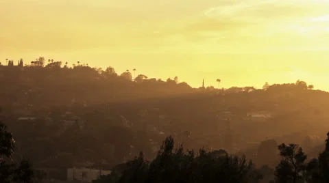 Sun rays moving over Hollywood Hills at sunset Video stock 64273358