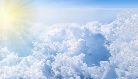Sun rays over clouds. Aerial view from airplane window. Stock Photos