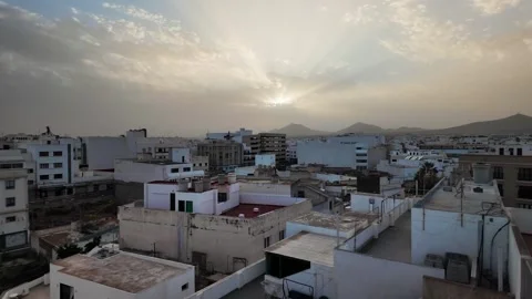 Sun rays over mountains and cityscape of Arrecife at sunset, Lanzarote Stock Footage 346375663