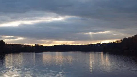Sun rays over the water surface Stock Photos