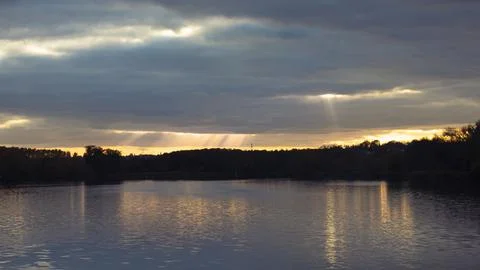 Sun rays over the water surface Stock Photos