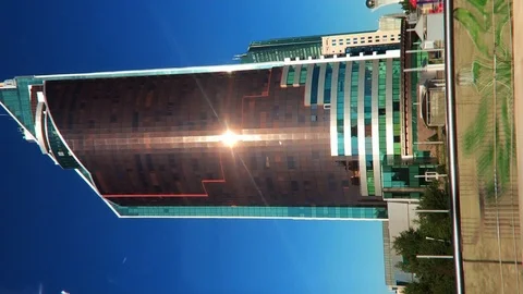 Sun rays on the panoramic windows of a high-rise building. Vertical video. Stock Footage 113673203
