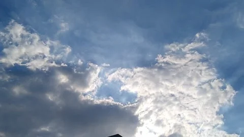 Sun Rays Piercing Through Fluffy White Clouds Stock Footage 339168052