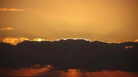 Sun rays in the red sky behind the clouds, in timelapse. Stock Footage 246709969