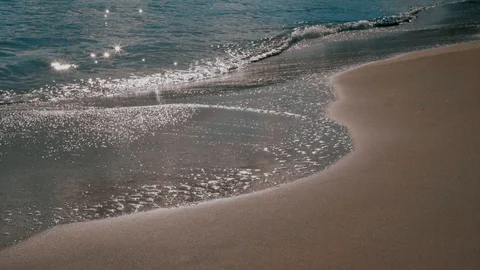 Sun rays reflect of waves and beach sand Stock Footage 123243853