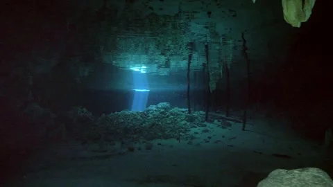 Sun rays reflecting on cave floor underwater Stock Footage 331791325