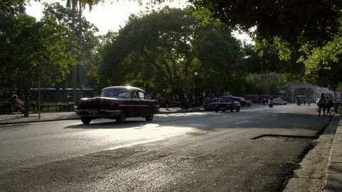 Sun rays reflects on classic American 1950's vintage car, old street in Havana Stock Footage 99841993