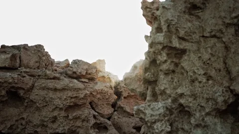 Sun rays shine between large dry coral cliff in the reserve of Ras Mohammed Stock Footage 296228697