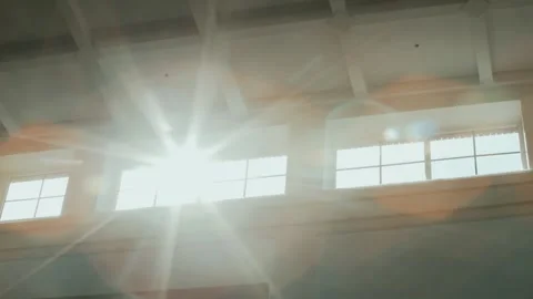 Sun rays shine brightly into windows near white figured ceiling with cells Stockbeeldmateriaal 145742283