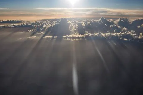 Sun rays shine through the clouds. Stock Photos