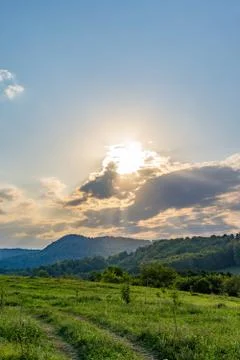 Sun rays shine through the clouds in the mountains. Stock Photos