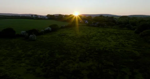 Sun Rays Shine Through Smoke Over Beutiful Farmland Stock Footage 243285725