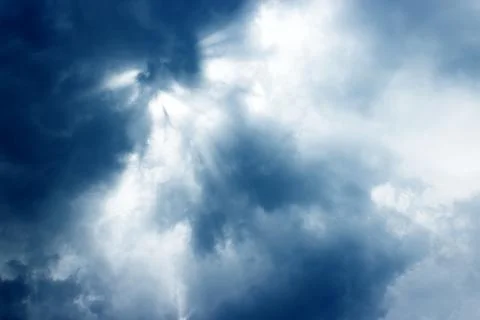 Sun rays of shining down with light god and dark clouds. Stock Photos