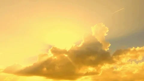 Sun rays shining through cinematic golden clouds at sunset Stock Footage 332874050