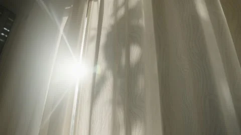 Sun rays shining through closed or shut window curtain in house or apartment Vídeo Stock 225936636