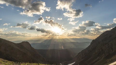 Sun rays shining through clouds during mountain sunrise Stock Footage 167178280