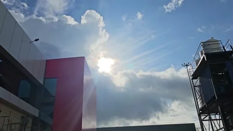 Sun Rays Shining Through Clouds Above Modern Buildings Stock Footage 321425482