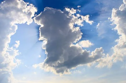 Sun rays shining through clouds Stock Photos