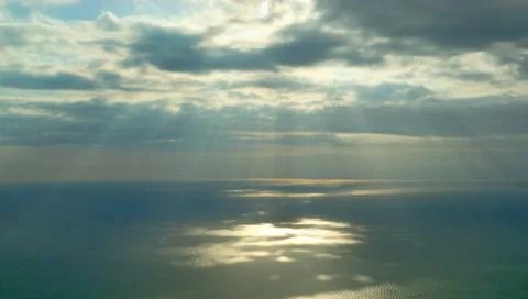 Sun rays shining through clouds Stock Photos