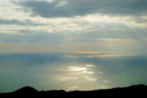 Sun rays shining through clouds Stock Photos