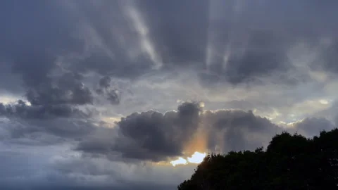 Sun rays shining through dark clouds Video stock 245076866