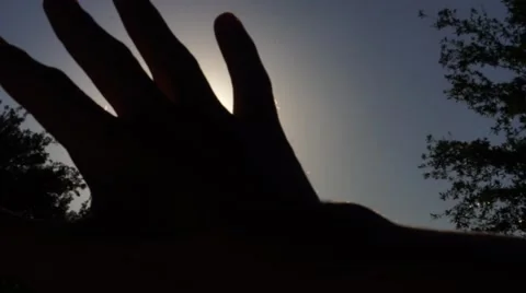 Sun Rays Shining Through Fingers Video stock 62957317