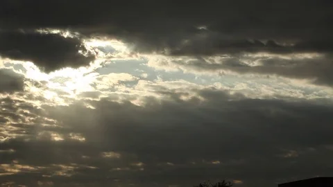 Sun rays shinning through dramatic clouds, pan Stock Footage 80440070