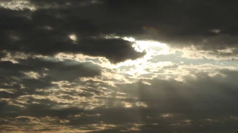 Sun rays shinning through dramatic clouds, pan Stock Footage 80440124