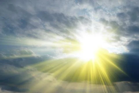 Sun rays sprouting through the clouds   Paradise Stock Photos
