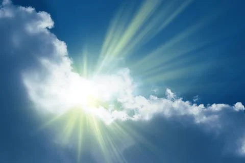 Sun rays sprouting through the clouds   Paradise Stock Photos
