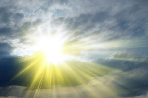 Sun rays sprouting through the clouds   Paradise Stock Photos