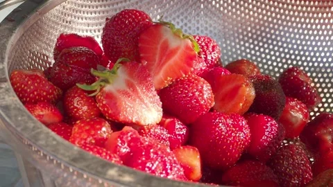 Sun rays Strawberries Cut in metal sieve Stock Footage 318971806
