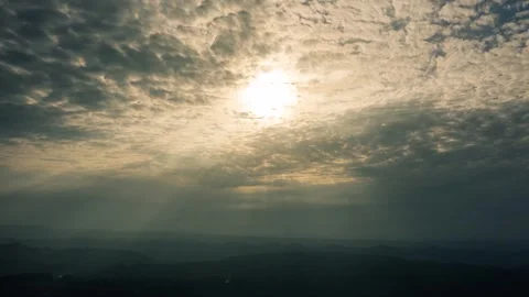 Sun Rays Streaming Through Clouds Over Distant Mountain Horizon At Sunset Stock Footage 342090673