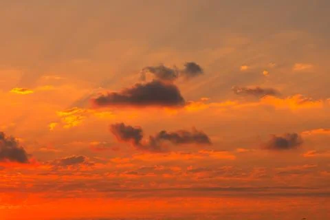 Sun rays at sunset with partly cloudy sky. Stock Photos