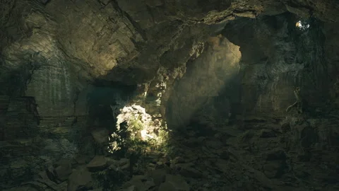 Sun rays through ceiling highlight textured underground surfaces beautifully Stock-Footage 339794220