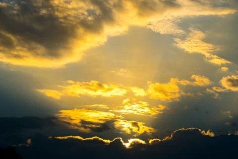 Sun rays through clouds like an dramatic explosion Stock Photos