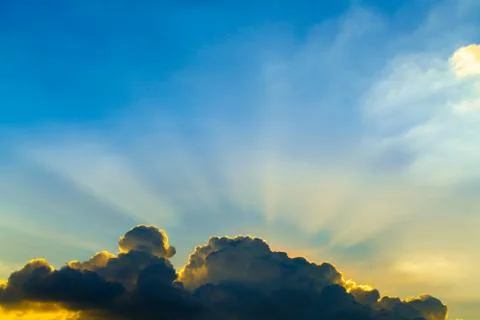 Sun rays through clouds like an dramatic explosion , power nature background. Stock Photos