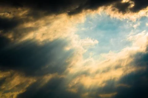 Sun rays through clouds like an dramatic explosion Stock Photos
