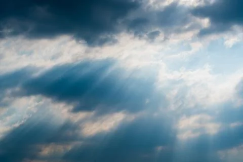 Sun rays through clouds like an dramatic explosion Stock Photos