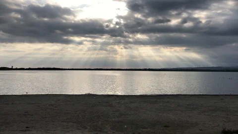 Sun Rays through the clouds at Larnaca Salt Lake Stock Footage 89673978