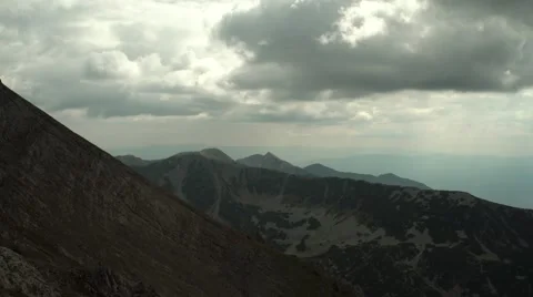 Sun Rays through Clouds on Mountain Range 4K Stock Footage 67478582