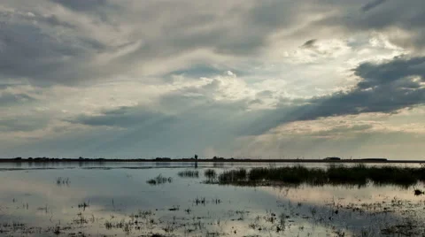 Sun rays through the clouds over the lake. Time Lapse Video stock 64916156