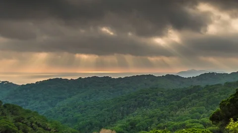 Sun rays through dark clouds over the sea time lapse Stock Footage 115271052